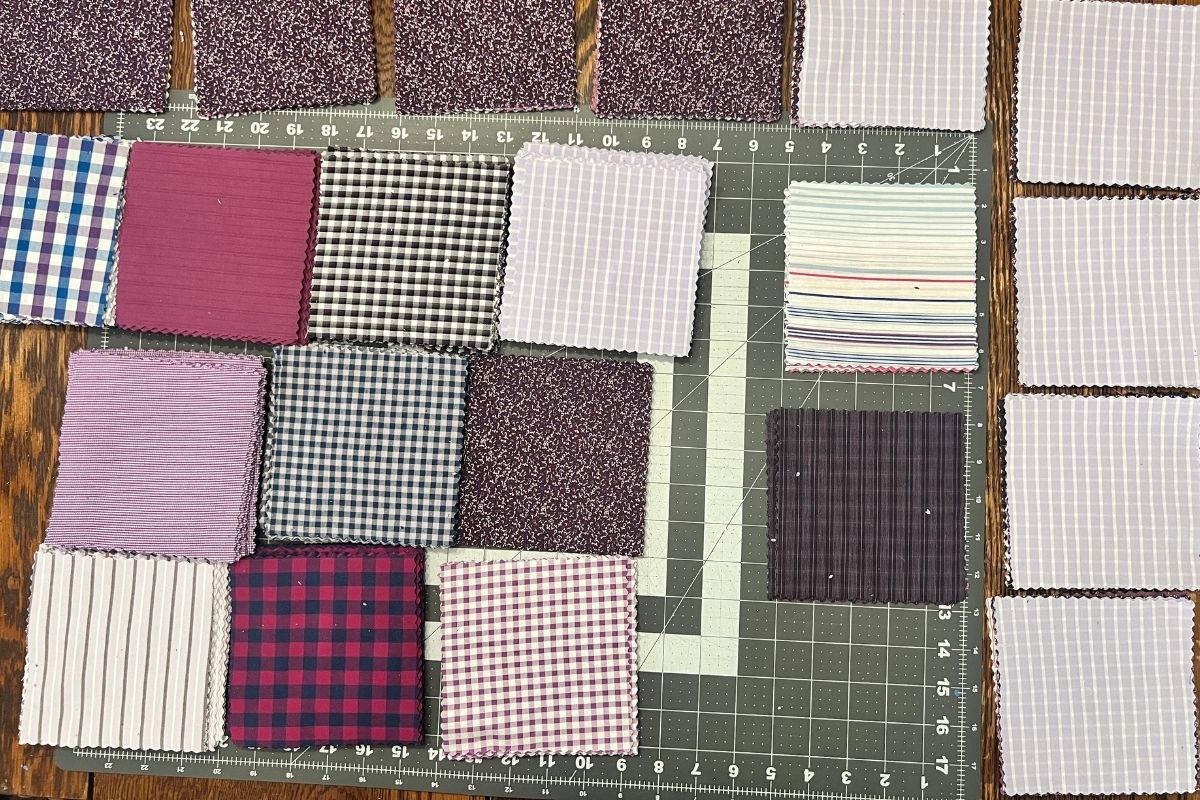 Five inch by five inch squares of fabric sorted into piles